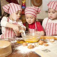 Three little chefs enjoying in the kitchen